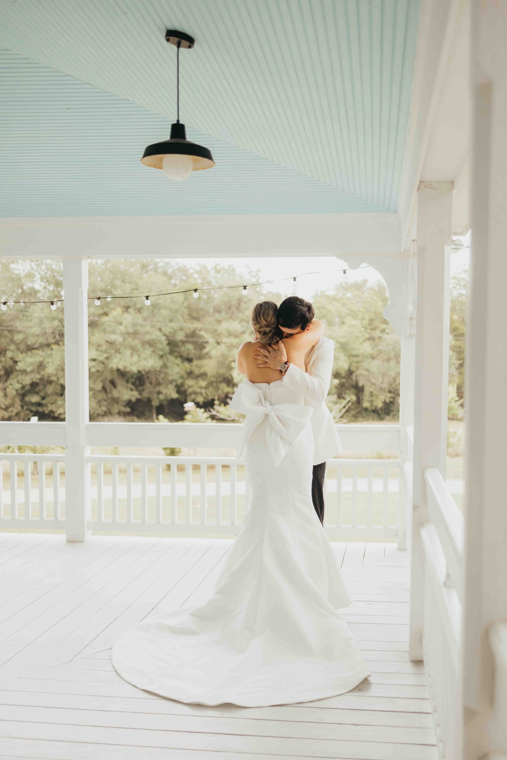 Pop Up Weddings in Houston, becoming increasingly popular. Bride hugs her groom on a patio in Roundtop Texas, after doing a first look before their ceremony.