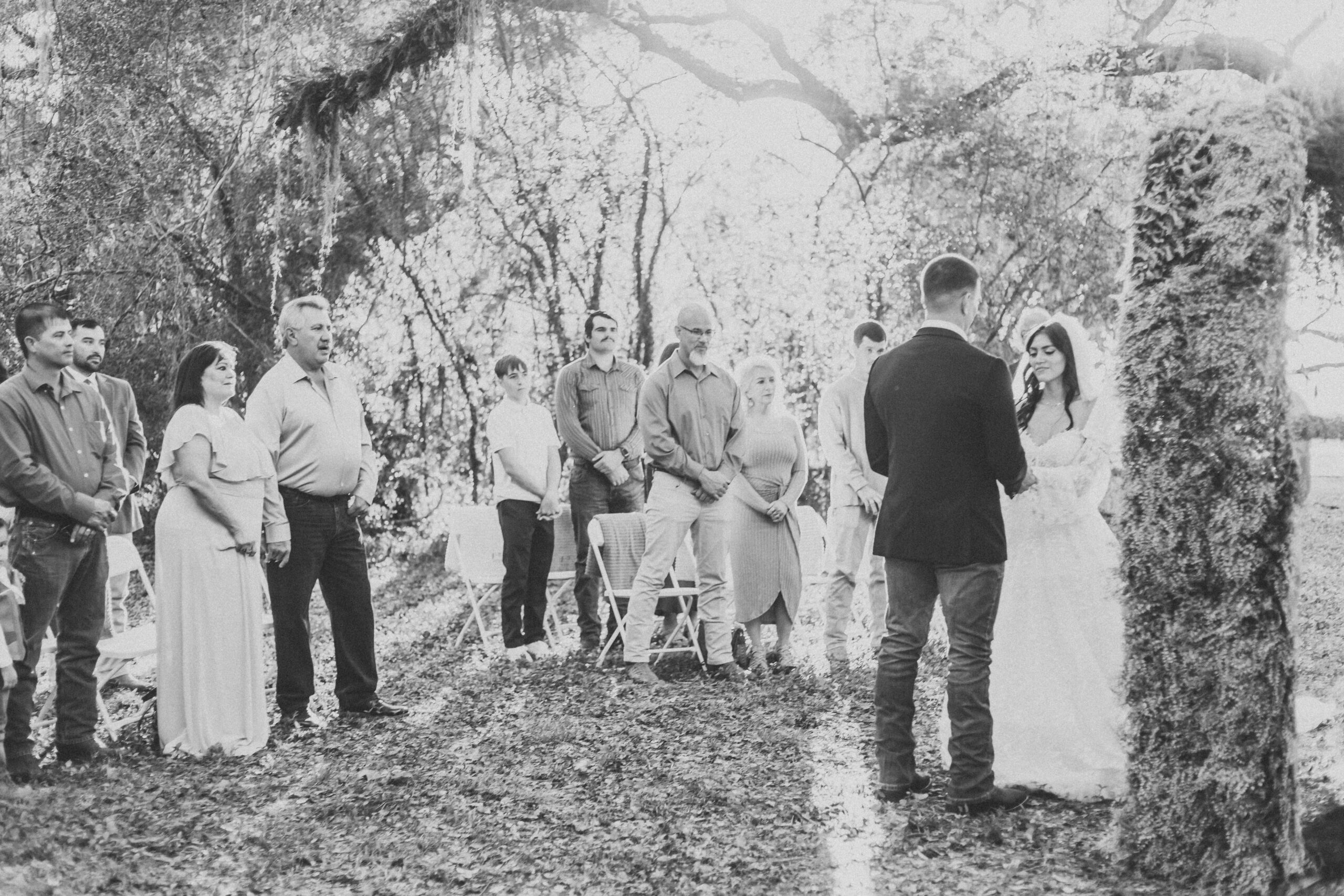 black and white image of micro wedding in houston. Bride and groom stand at alter of intimate wedding ceremony.
