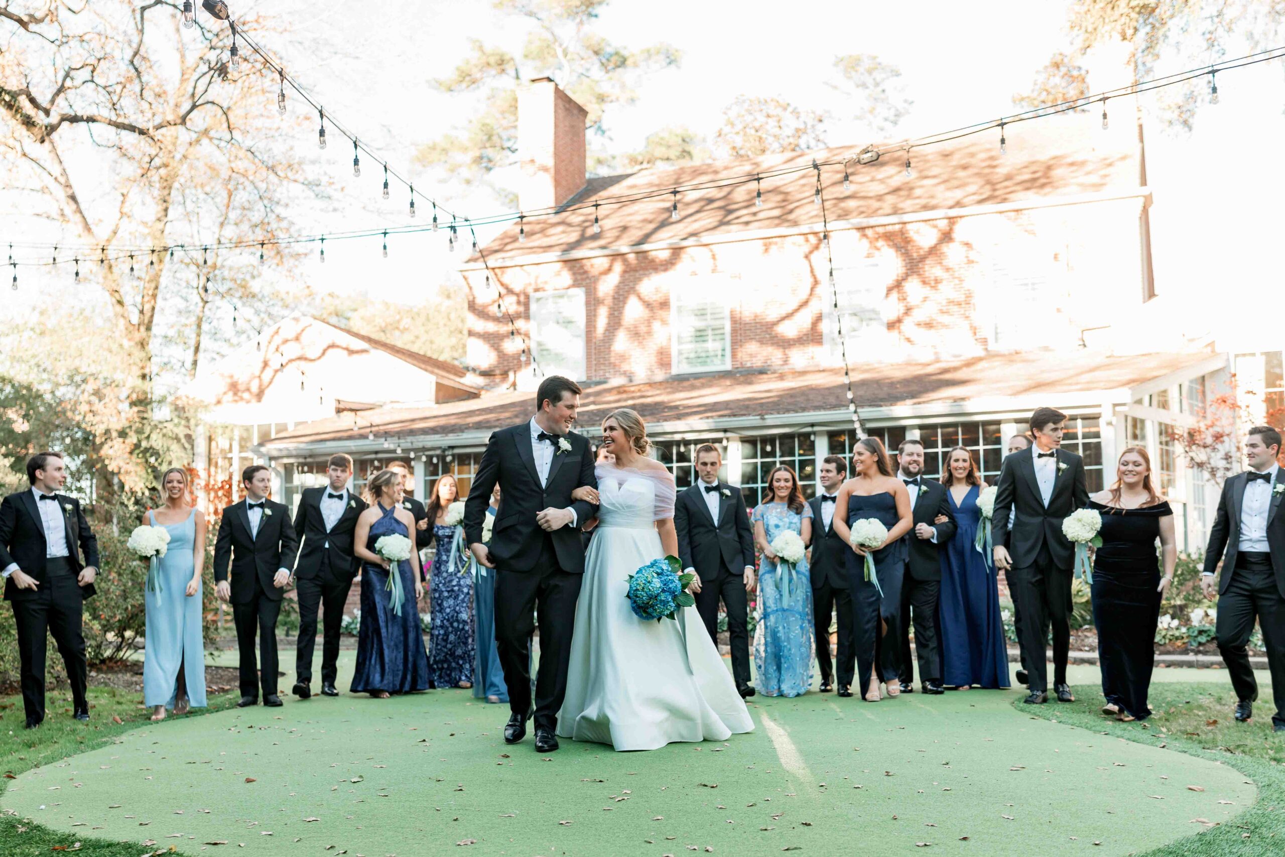 Bridal Party celebrates the couple with outdoor vows at their Houston outdoor wedding venue.